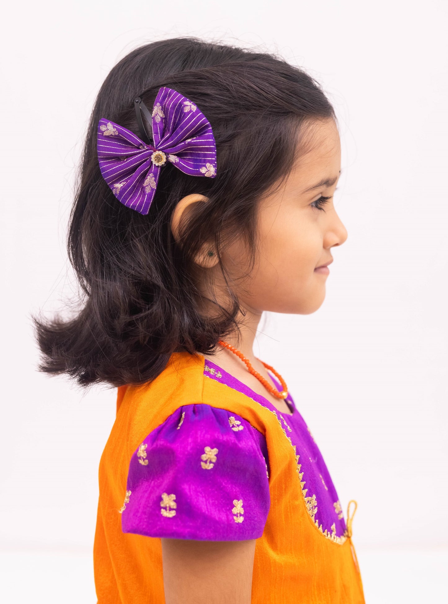 Purple mysore silk tulip dhoti and orange raw silk tunics set with an intricate embroidered yoke pattern for Girls.Let your princess be as comfortable as in her casuals with carefully designed & crafted Comfort Ethnic Wear by Soyara Ethnics.Keep her fashion quotient high with timeless patterns, vibrant combinations and royal textiles.