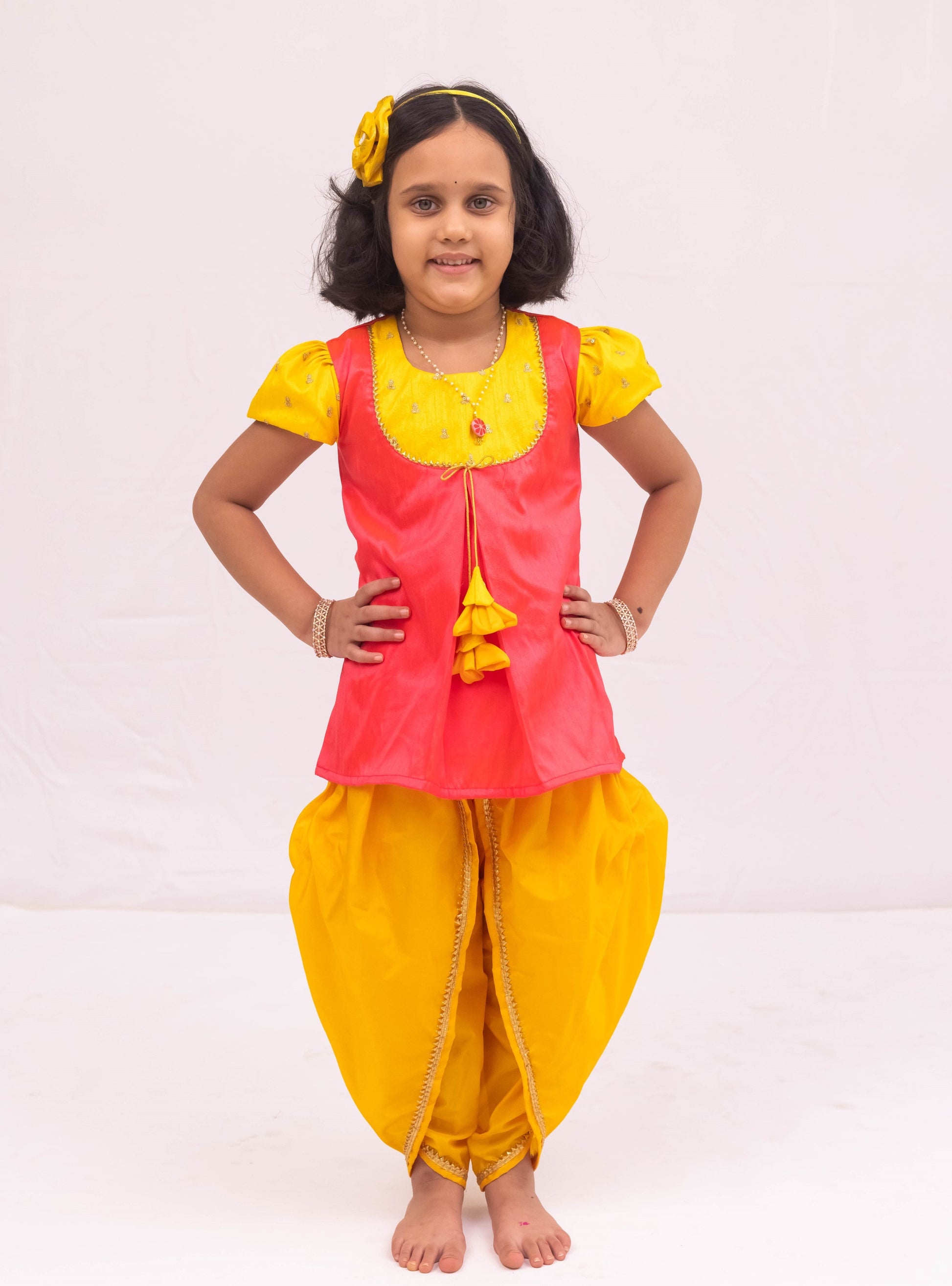 Yellow mysore silk tulip dhoti and candy pink raw silk tunics set with an intricate embroidered yoke pattern for Girls.Let your princess be as comfortable as in her casuals with carefully designed & crafted Comfort Ethnic Wear by Soyara Ethnics.Keep her fashion quotient high with timeless patterns, vibrant combinations and royal textiles.