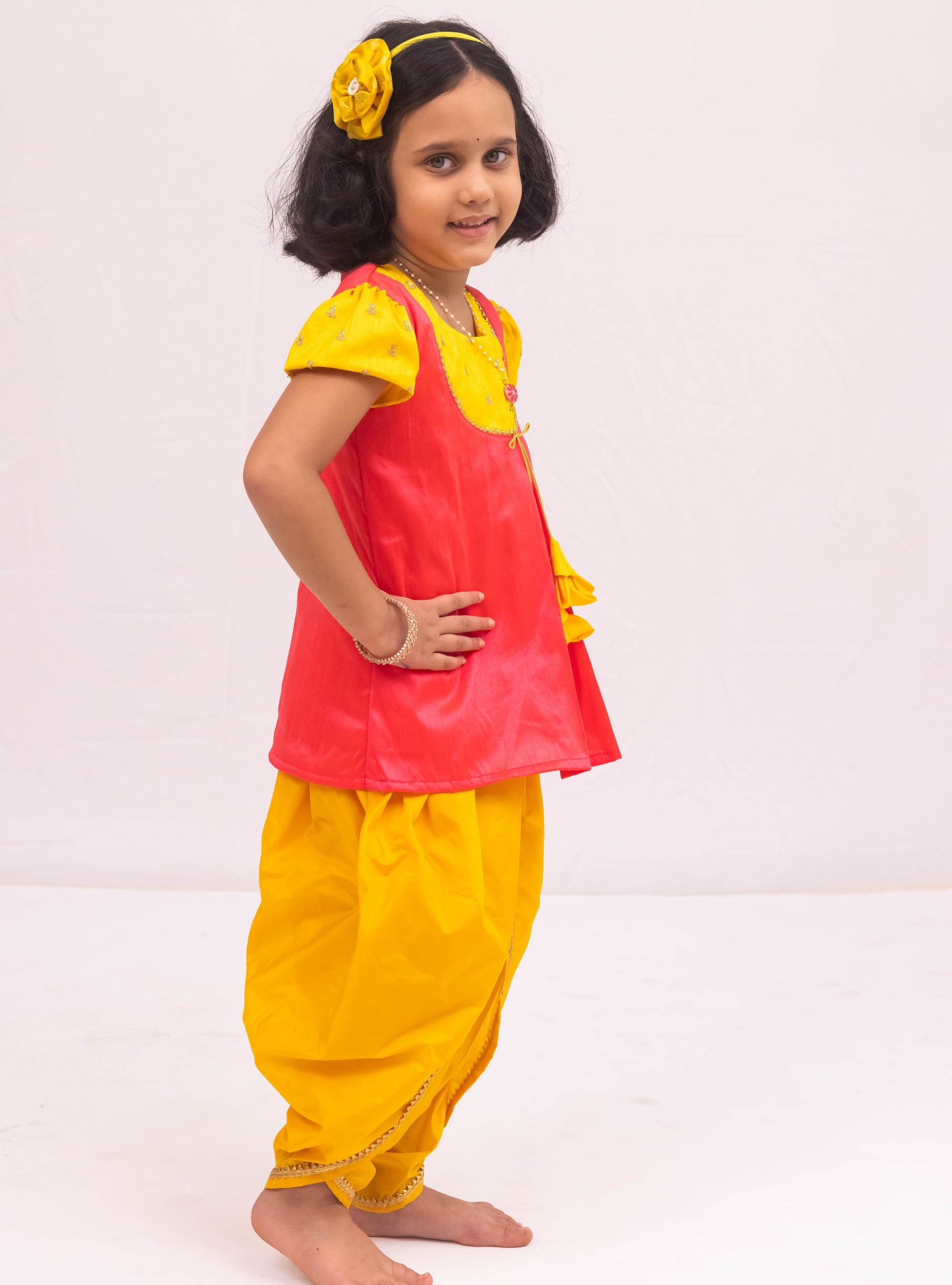 Yellow mysore silk tulip dhoti and candy pink raw silk tunics set with an intricate embroidered yoke pattern for Girls.Let your princess be as comfortable as in her casuals with carefully designed & crafted Comfort Ethnic Wear by Soyara Ethnics.Keep her fashion quotient high with timeless patterns, vibrant combinations and royal textiles.