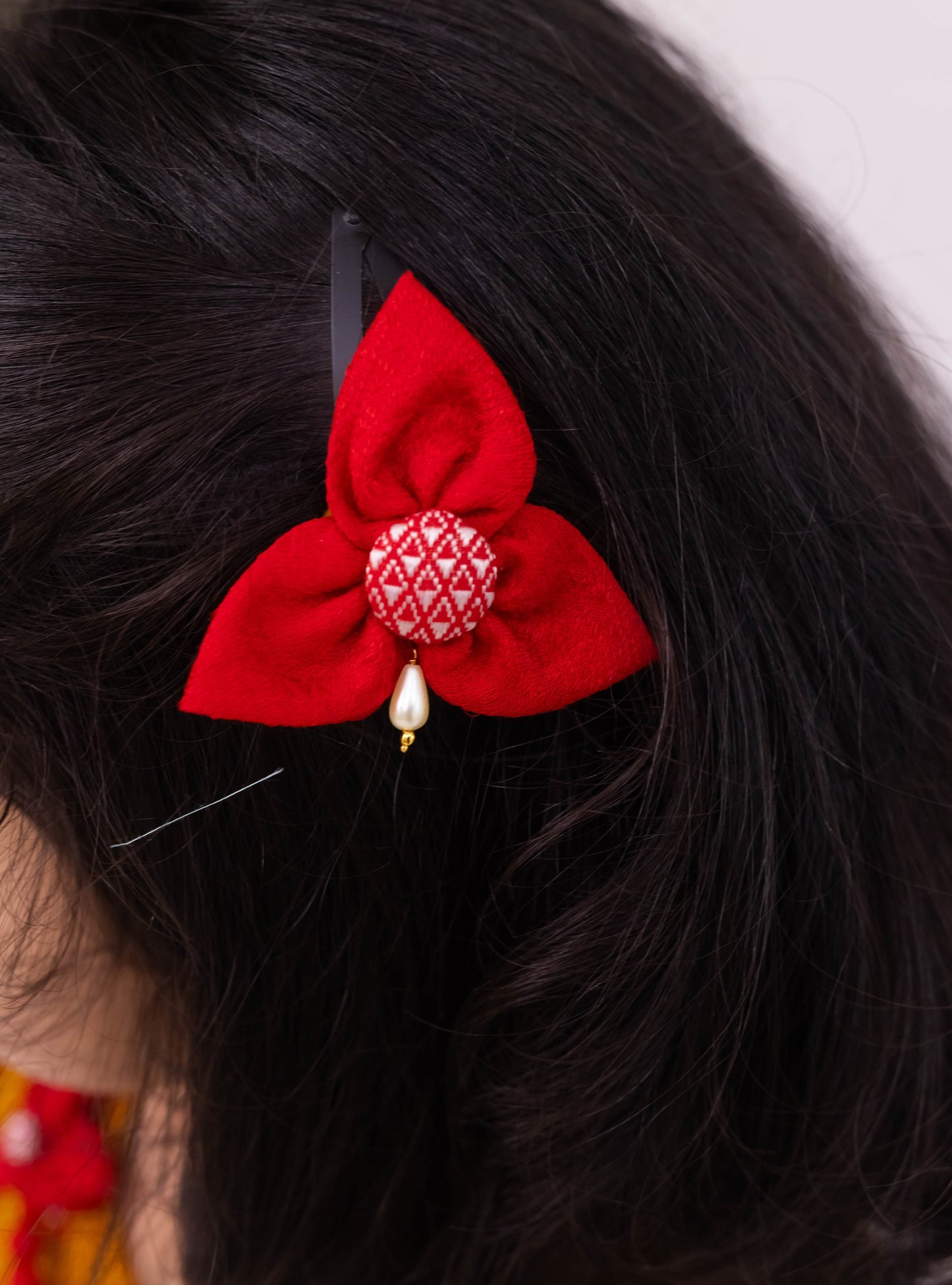 Bright Red Khunn Dress with Contrast Turmeric Yellow hand embroidered blouse with cute puff sleeves. Apple cut blouse has cute flower latkans on both sides that dangle while walking. Also Unique Patti border of khunn is something not to miss for Khunn lovers