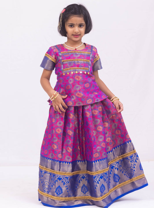 Pink- Dark Blue jacquard brocade Pattu Pavada Parkar Polka set with a heavy yoke pattern for Girls.Let your princess be as comfortable as in her casuals with carefully designed & crafted Comfort Ethnic Wear by Soyara Ethnics.Keep her fashion quotient high with timeless patterns, vibrant combinations and royal textiles.