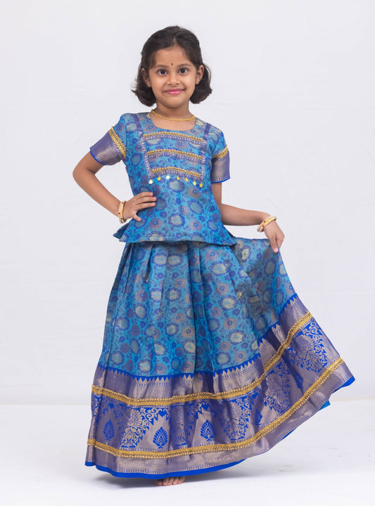 Blue banarasi jacquard brocade Pattu Pavada Parkar Polka set with a heavy yoke pattern for Girls.Let your princess be as comfortable as in her casuals with carefully designed & crafted Comfort Ethnic Wear by Soyara Ethnics.Keep her fashion quotient high with timeless patterns, vibrant combinations and royal textiles.