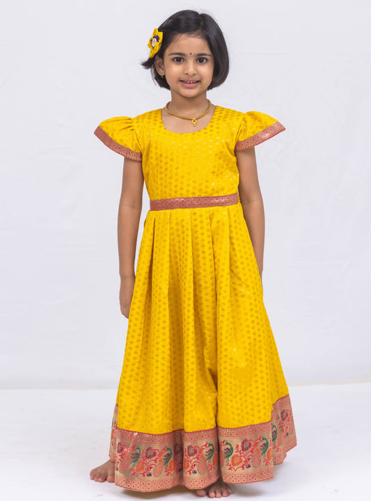 Sunshine yellow chanderi brocade puff sleeves gown with bright pink paithani border for Girls.Let your princess be as comfortable as in her casuals with carefully designed & crafted Comfort Ethnic Wear by Soyara Ethnics.Keep her fashion quotient high with timeless patterns, vibrant combinations and royal textiles.