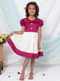 Magenta brocade silk and Ivory Mysore silk dress with Peter pan collar and puffed sleeves for Girl.Let your princess be as comfortable as in her casuals with carefully designed & crafted Comfort Ethnic Wear by Soyara Ethnics.Keep her fashion quotient high with timeless patterns, vibrant combinations and royal textiles.