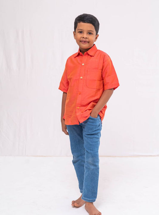 This Coral orange Plain Raw silk half sleeved shirt is designed for boys, providing both comfort and style.