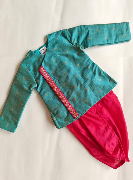 Sea green taffeta silk kurta with pink lace and contrast pomegranate pink mysore silk dhoti for Baby Boy.It's the perfect outfit for your baby's naming ceremony,naamkaran,annaprashan ceremony.Traditional dress for Noolukettu Ceremony,Pachavi Puja,cradle ceremony,Rice Ceremony,Chatti Puja etc. Apt gifting idea.