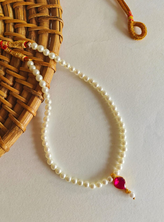 This necklace features semi-cultured pearls and a Karwari Drop shaped Pink Stone Pendant, perfect for girls. The length is 13 inches with an adjustable drawstring for added convenience.