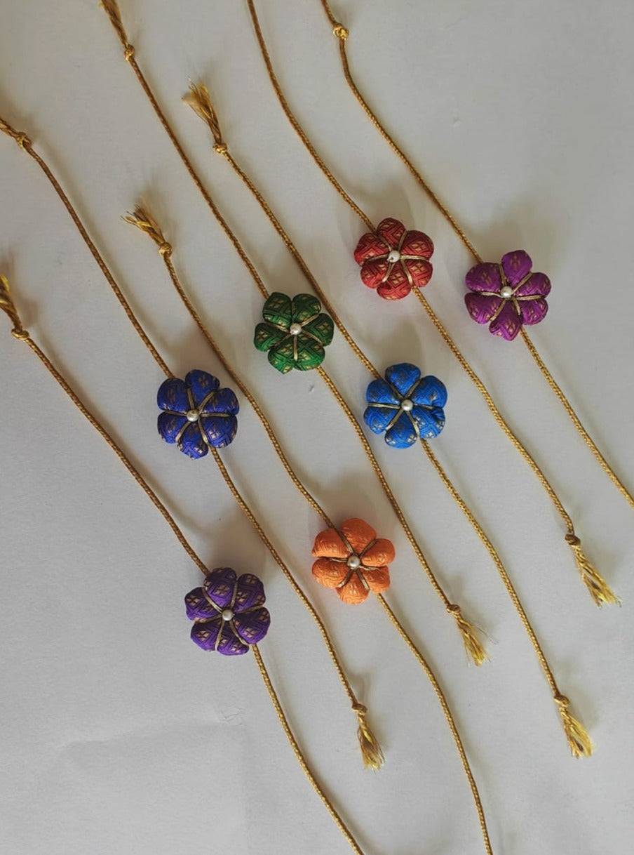 Fabric flower rakhi with golden cord Suitable for all ages.