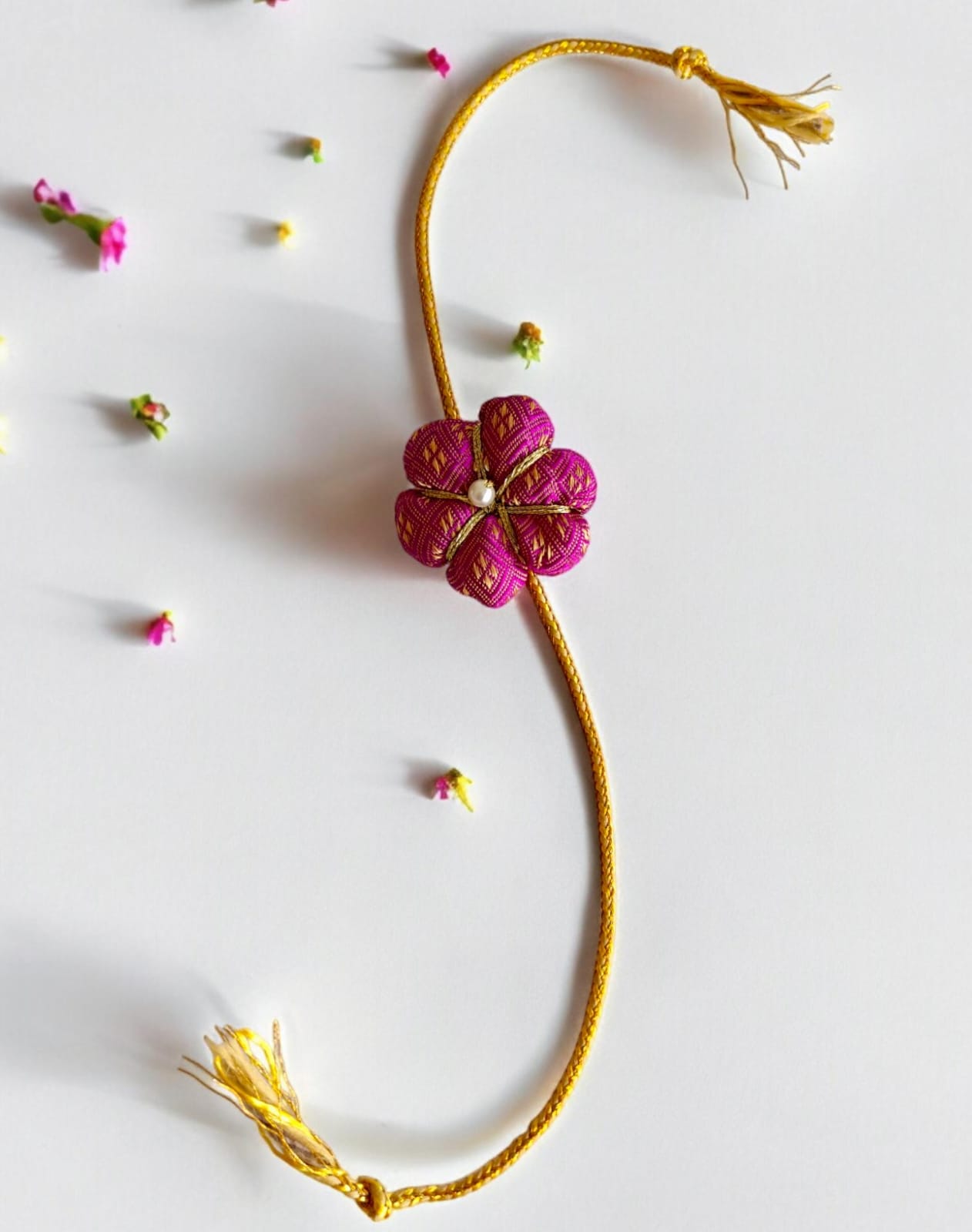 Fabric flower rakhi with golden cord