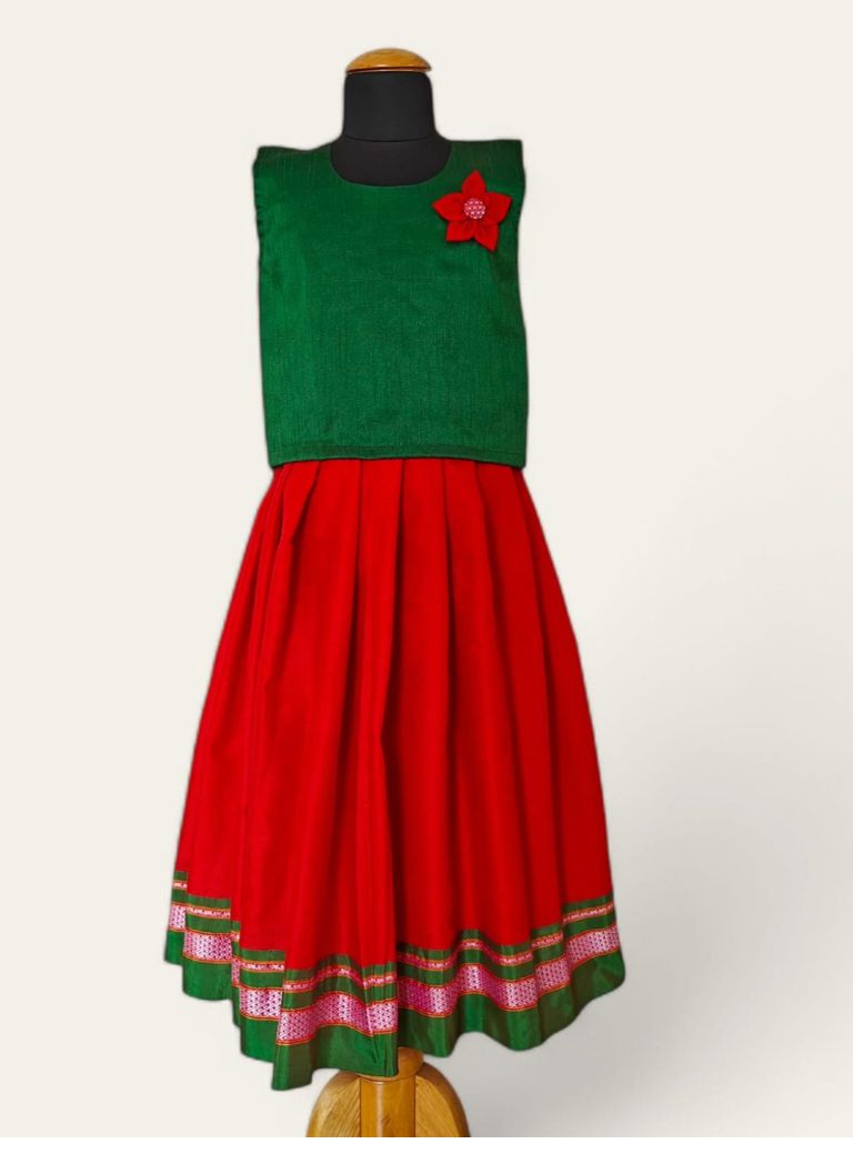 Red handloom khunn parkar with green border and green raw silk sleeveless blouse with handcrafted flower motif Girls