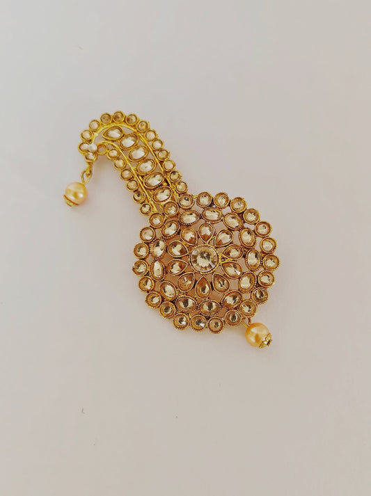 Golden kundan studded circle shaped kalangi / pagadi brooch for batu or groom.