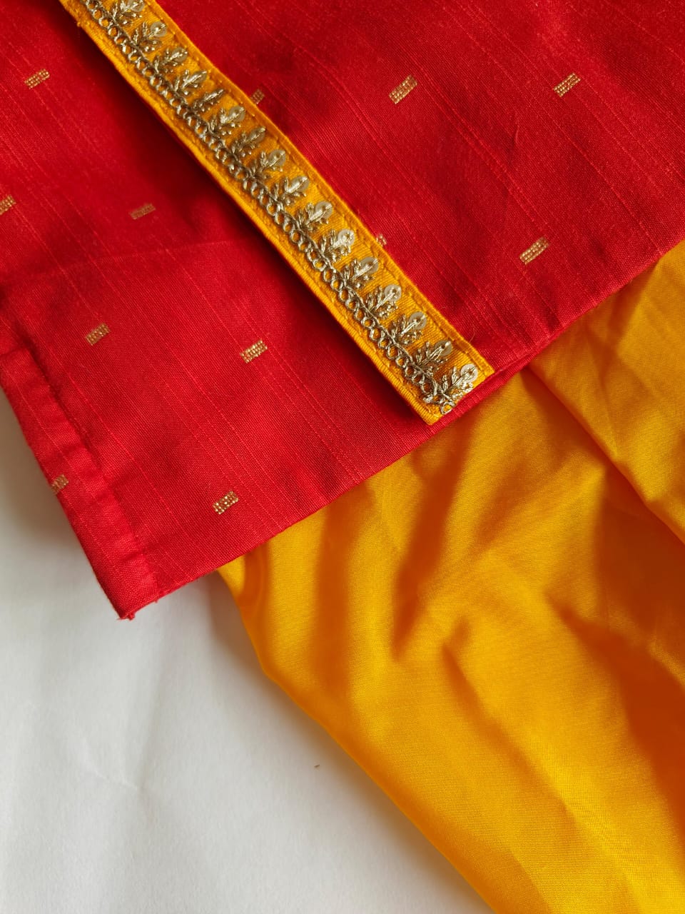 Bright red pine silk kurta with contrast yellow mysore silk dhoti for Baby Boy.It's the perfect outfit for your baby's naming ceremony,naamkaran,annaprashan ceremony.Traditional dress for Noolukettu Ceremony,Pachavi Puja,cradle ceremony,Rice Ceremony,Chatti Puja etc. Apt gifting idea.