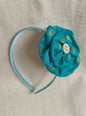 This Aqua Green Big Handcrafted fabric flower headband with pearls embellishment for Girls is expertly crafted with immense love and suitable for girls above the age of 2 years. The intricate handwork and delicate pearl detailing make it a standout accessory for any young girl.