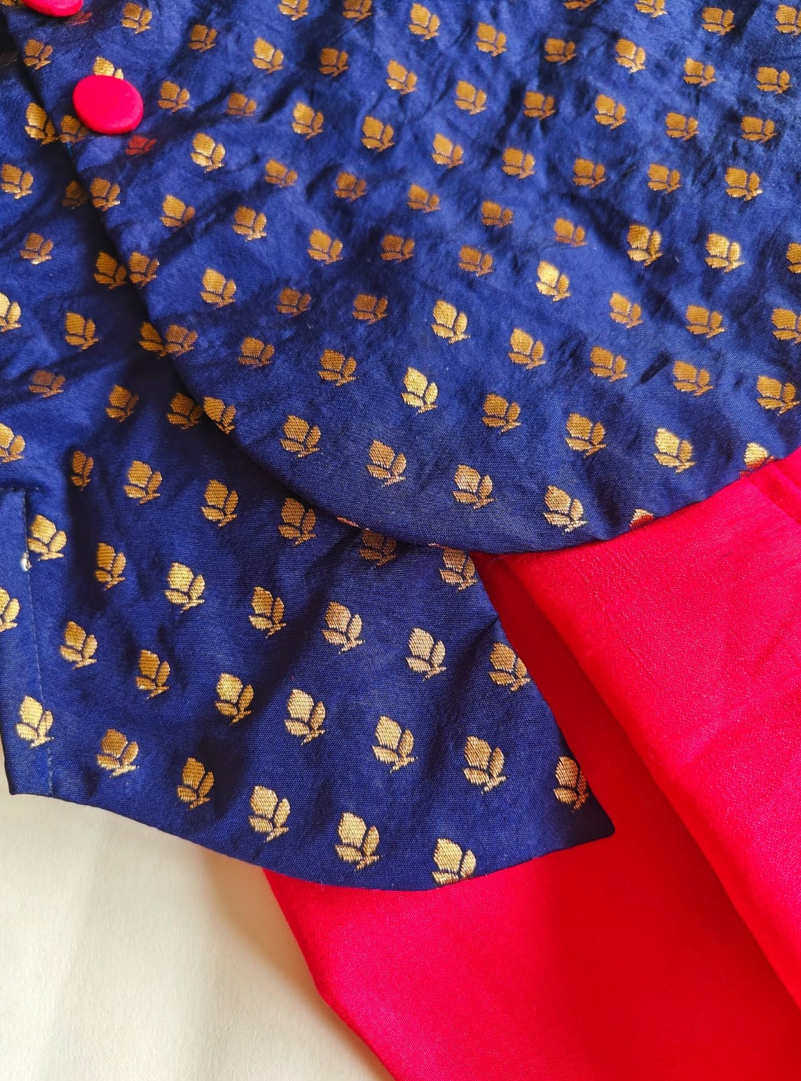 Navy blue brocade silk kurta with red fabric buttons teamed with red Italian crape silk dhoti for Baby Boy.It's the perfect outfit for your baby's naming ceremony,naamkaran,annaprashan ceremony.Traditional dress for Noolukettu Ceremony,Pachavi Puja,cradle ceremony,Rice Ceremony,Chatti Puja etc. Apt gifting idea