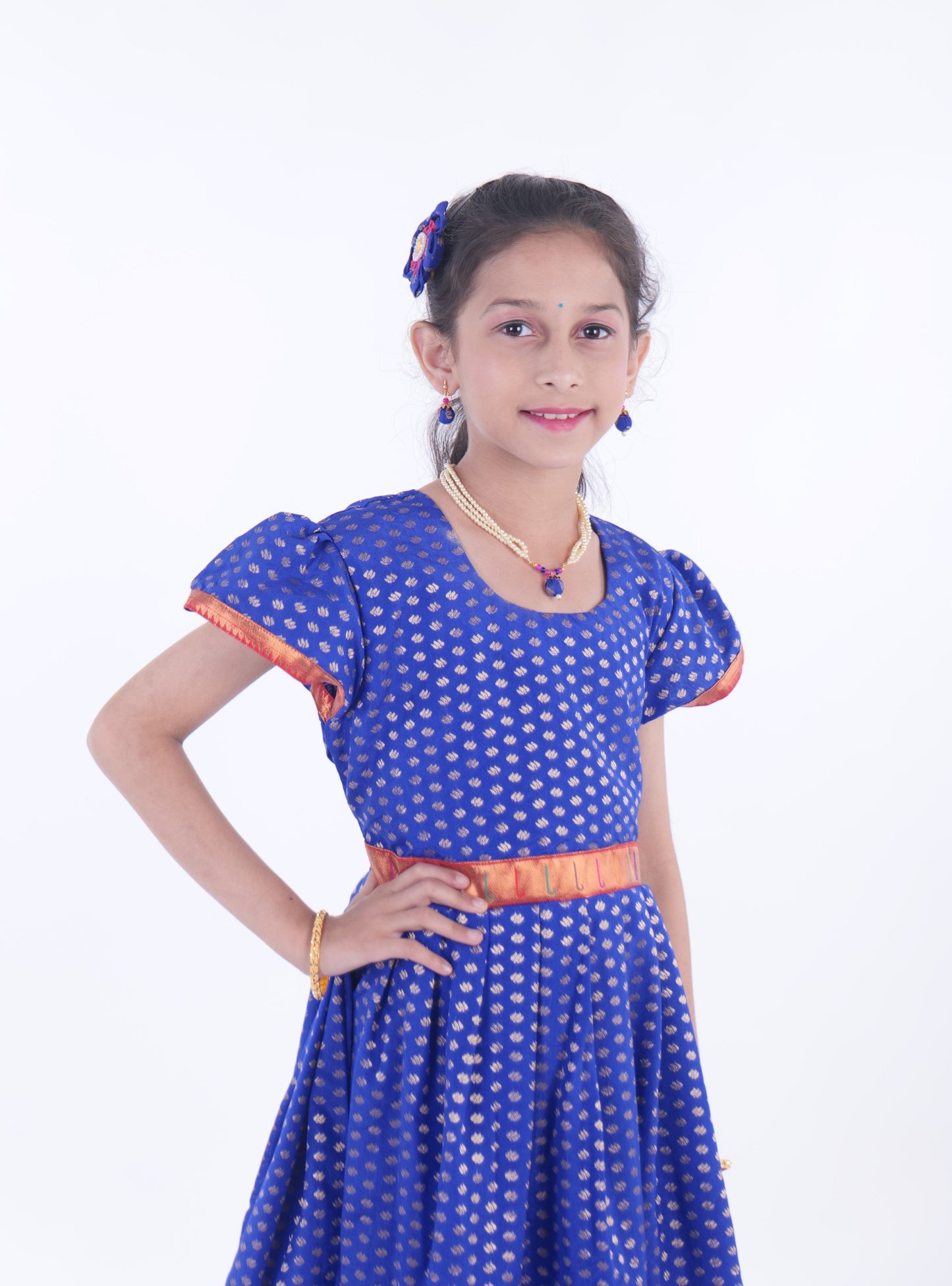 Royal Blue chanderi brocade puff sleeves gown with bright pink paithani border for Girls.Let your princess be as comfortable as in her casuals with carefully designed & crafted Comfort Ethnic Wear by Soyara Ethnics.Keep her fashion quotient high with timeless patterns, vibrant combinations and royal textiles.