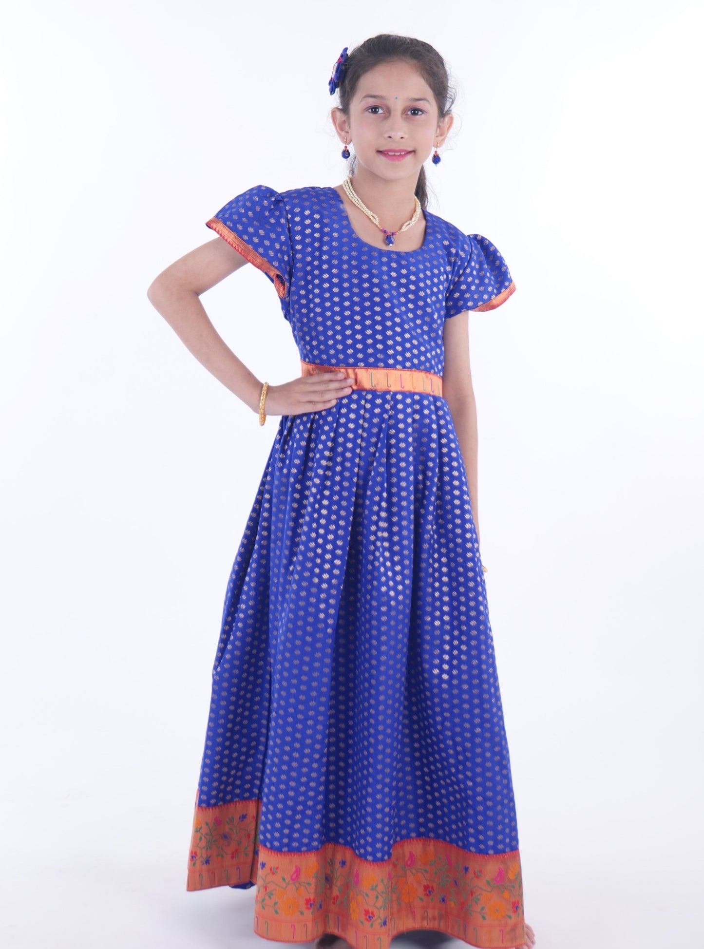 Royal Blue chanderi brocade puff sleeves gown with bright pink paithani border for Girls.Let your princess be as comfortable as in her casuals with carefully designed & crafted Comfort Ethnic Wear by Soyara Ethnics.Keep her fashion quotient high with timeless patterns, vibrant combinations and royal textiles.