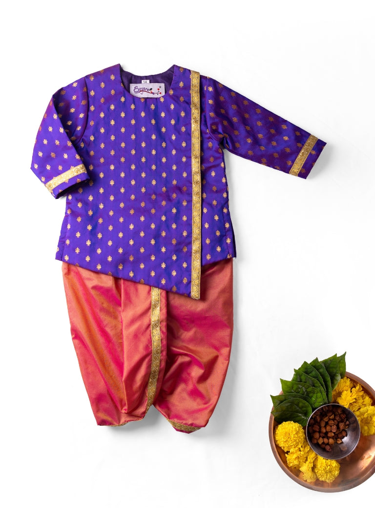 Purple brocade asymmetric kurta teamed with blush pink mysore silk dhoti for Newborn Baby Boy.It's the perfect outfit for your baby's naming ceremony,naamkaran,annaprashan ceremony.Traditional dress for Noolukettu Ceremony,Pachavi Puja,cradle ceremony,Rice Ceremony,Chatti Puja etc. Apt gifting idea.
