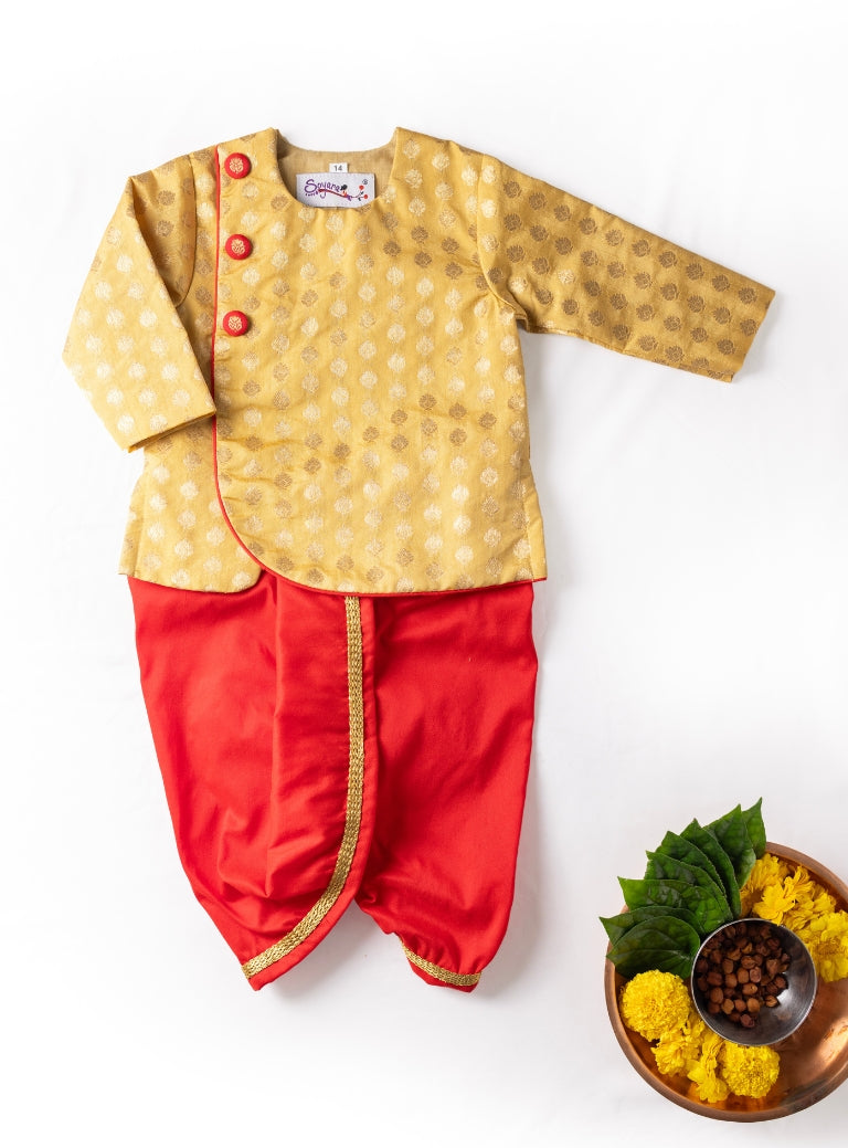 Golden brocade chanderi overlap kurta with red piping teamed with red cotton silk dhoti for Newborn Baby Boy.It's the perfect outfit for your baby's naming ceremony,naamkaran,annaprashan ceremony.Traditional dress for Noolukettu Ceremony,Pachavi Puja,cradle ceremony,Rice Ceremony,Chatti Puja etc. Apt gifting idea.