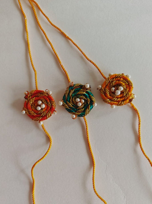 Set of 3 Spiralled fabric chord rakhis with pearls embellishments