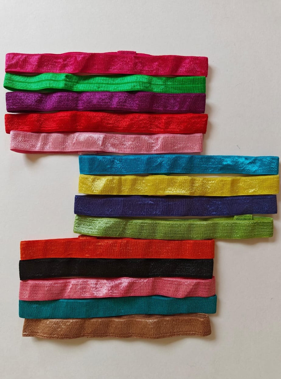 Set of 14 plain satin elastic headbands for a baby girl.Golden brocade bonnet,paithani booties,fabric headbands all these Handcrafted accessories for Newborn are perfect add ons to any traditional attire of the baby. Designer baby mats, set of generic bloomers are the other naming ceremony essentials.