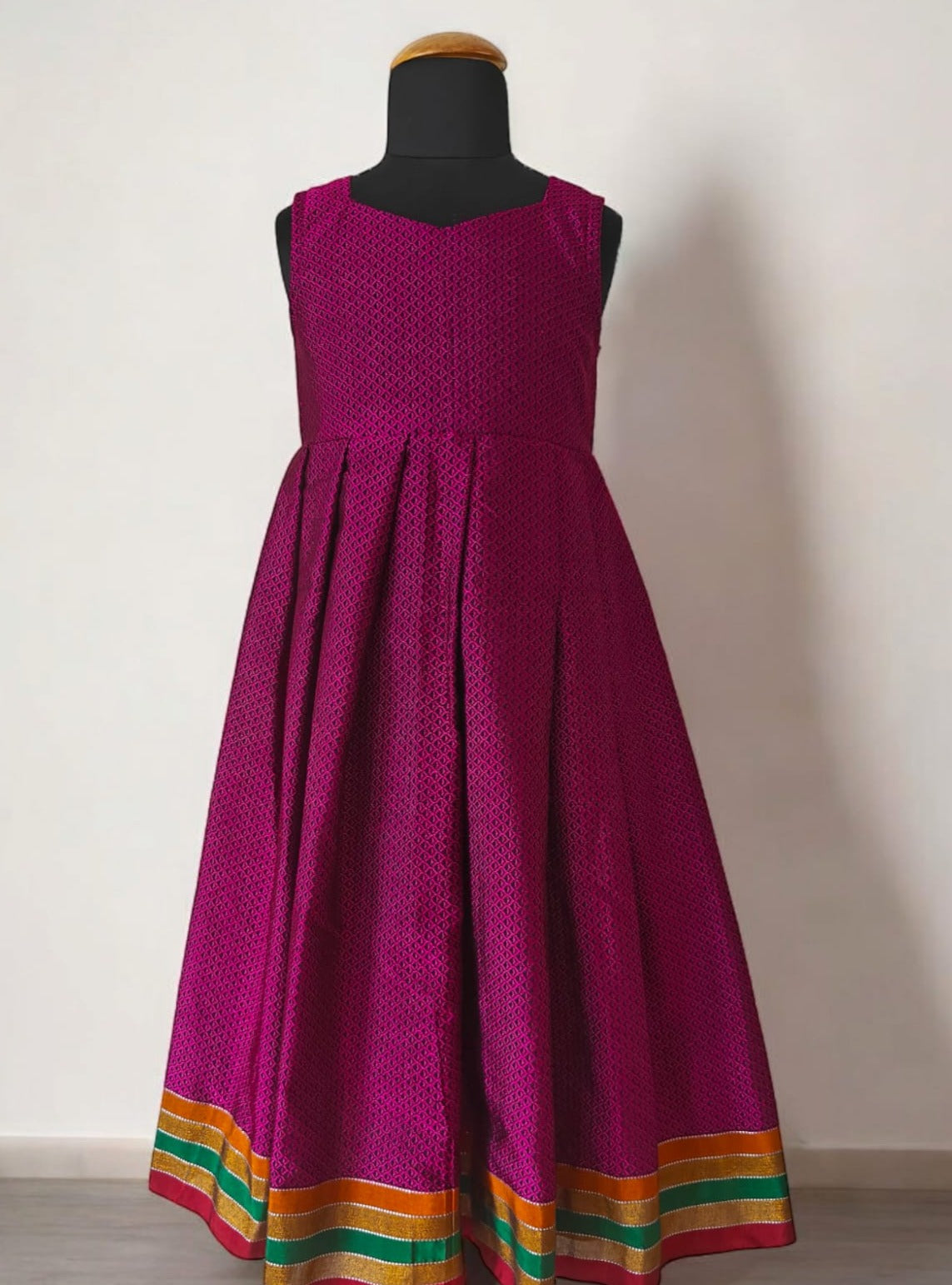 Magenta Khunn Dress with Contrast Turmeric Yellow hand embroidered blouse with cute puff sleeves. Apple cut blouse has cute flower latkans on both sides that dangle while walking. Also Unique Patti border of khunn is something not to miss for Khunn lovers