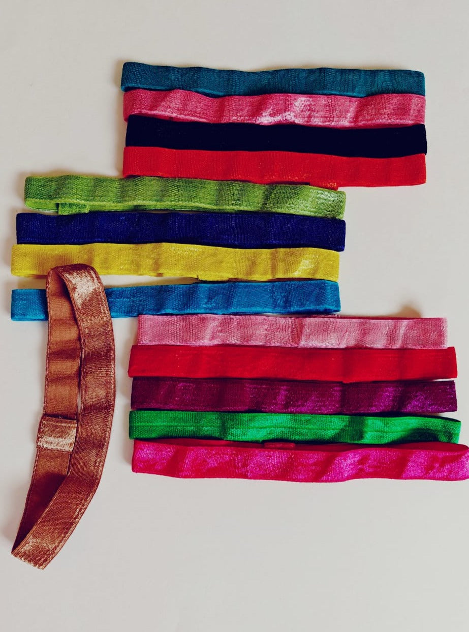 Set of 14 plain satin elastic headbands for a baby girl.Golden brocade bonnet,paithani booties,fabric headbands all these Handcrafted accessories for Newborn are perfect add ons to any traditional attire of the baby. Designer baby mats, set of generic bloomers are the other naming ceremony essentials.