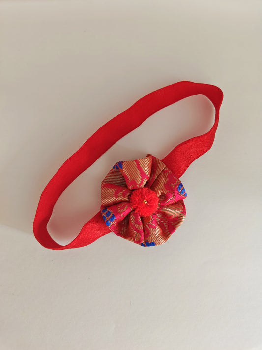 Red paithani fabric flower elasticated headband for baby girl.