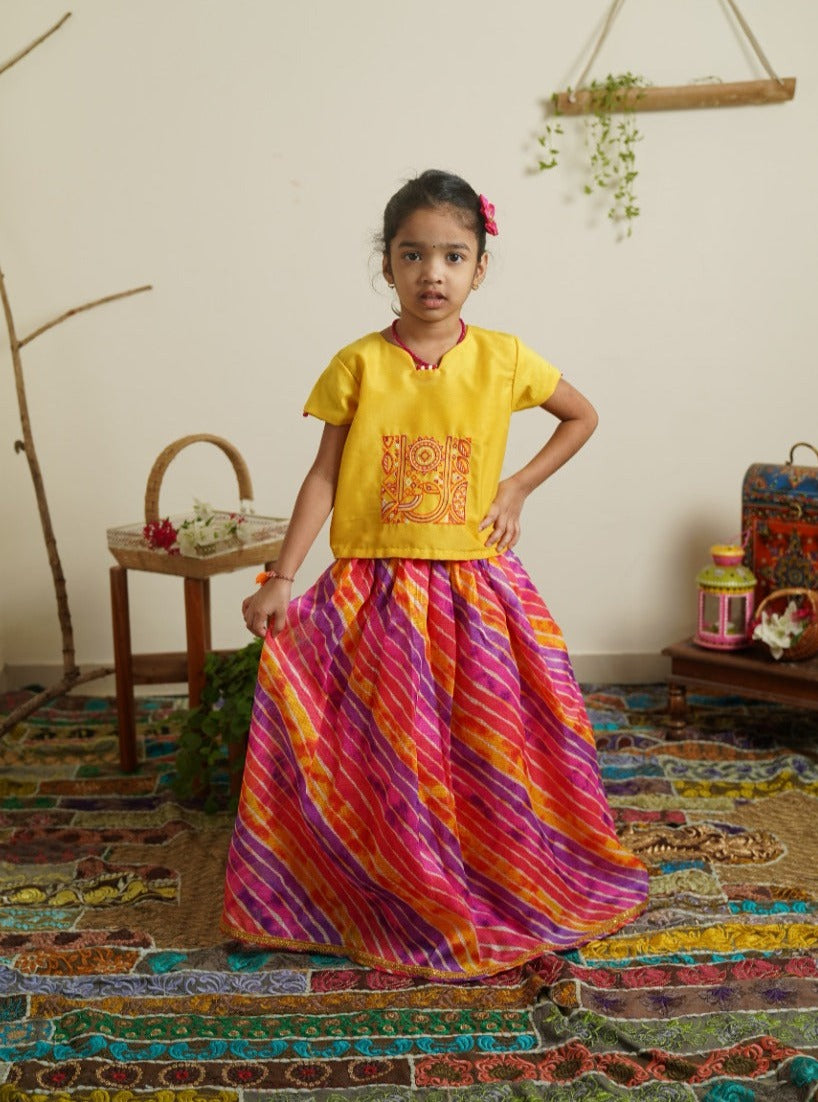 Purple pink yellow leheriya kotta elasticated long skirt with sunshine yellow cotton silk crop top.Let your princess be as comfortable as in her casuals with carefully designed & crafted Comfort Ethnic Wear by Soyara Ethnics.Keep her fashion quotient high with timeless patterns, vibrant combinations and royal textiles.
