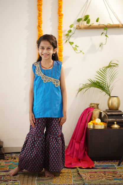 Brocade chanderi coffee brown sharara pants with peacock blue pure raw silk tunic.Let your princess be as comfortable as in her casuals with carefully designed & crafted Comfort Ethnic Wear by Soyara Ethnics.Keep her fashion quotient high with timeless patterns, vibrant combinations and royal textiles.