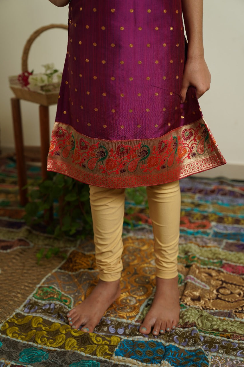 Dark Magenta colored semi silk brocade kurti with paithani neck pattern and daman.Let your princess be as comfortable as in her casuals with carefully designed & crafted Comfort Ethnic Wear by Soyara Ethnics.Keep her fashion quotient high with timeless patterns, vibrant combinations and royal textiles.