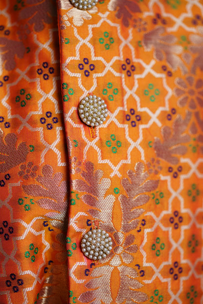 Light Orange Brocade jacket with multi color bandhani design .Cotton lining from inside avoid sweating but give warmth.Statement embellished buttons add royal charm to these jackets. Team these with any plain colored kurta or satin shirt for best festive look!