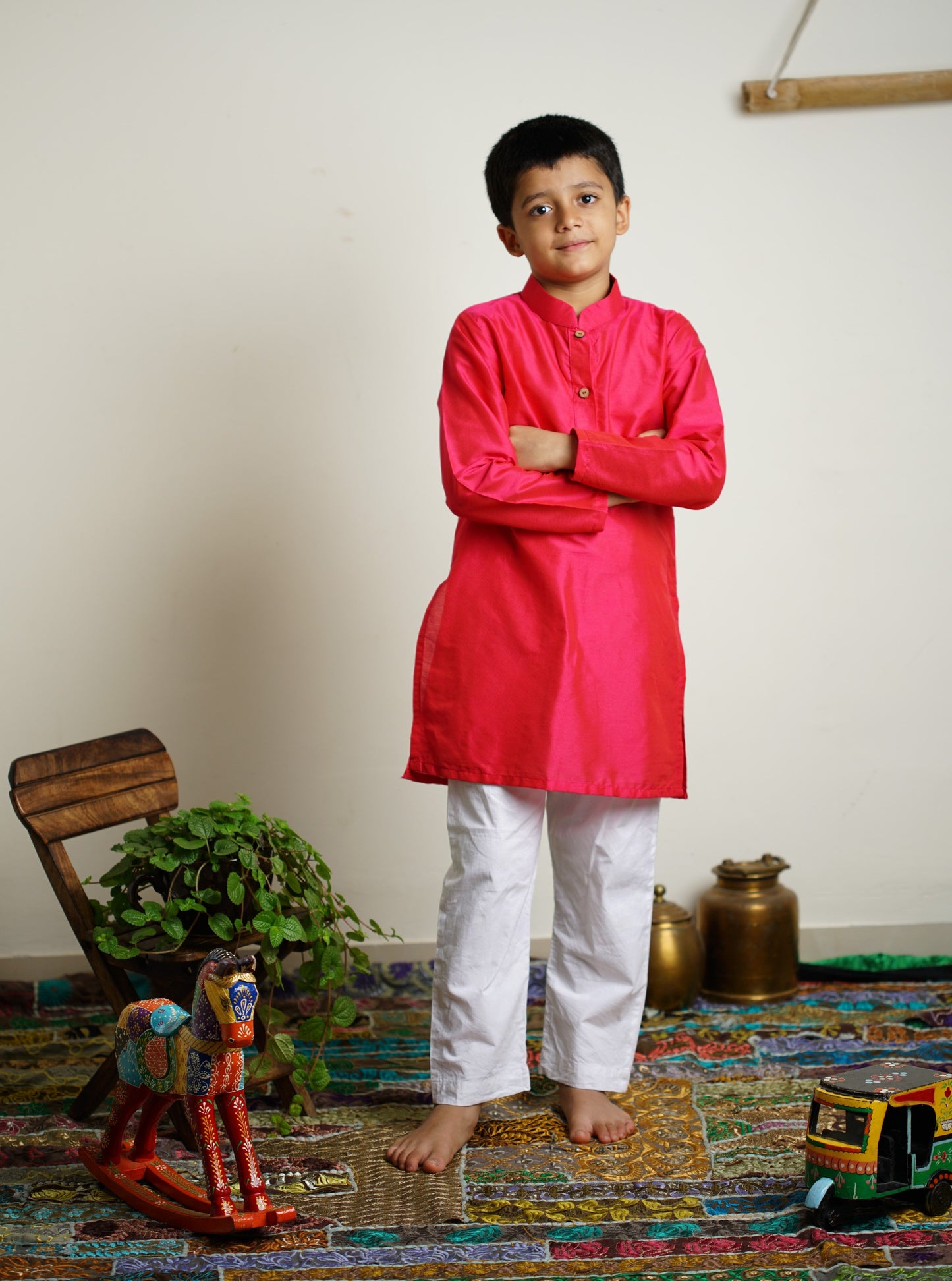 Fuchsia (dark pink) cotton silk stand collar long kurta with wooden buttons.Kurtas with collar or Angrakha pattern teamed with salwar are the best choice for any festive occasion for boys.They are Trendy, Easy to wear and comfortable to carry.