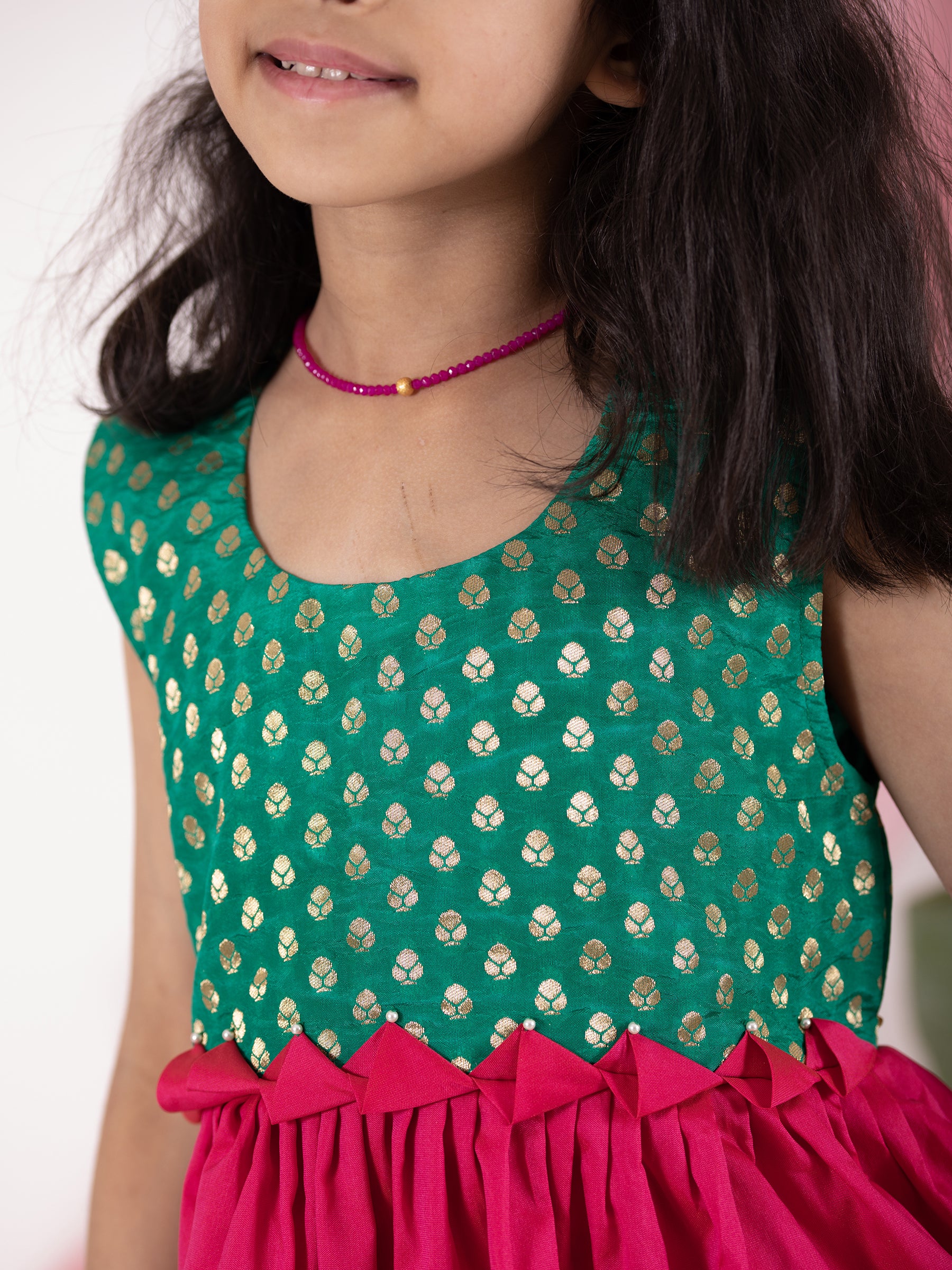 Rama Green brocade short bodice frock with dark pink bottom for Girls.Let your princess be as comfortable as in her casuals with carefully designed & crafted Comfort Ethnic Wear by Soyara Ethnics.Keep her fashion quotient high with timeless patterns, vibrant combinations and royal textiles.
