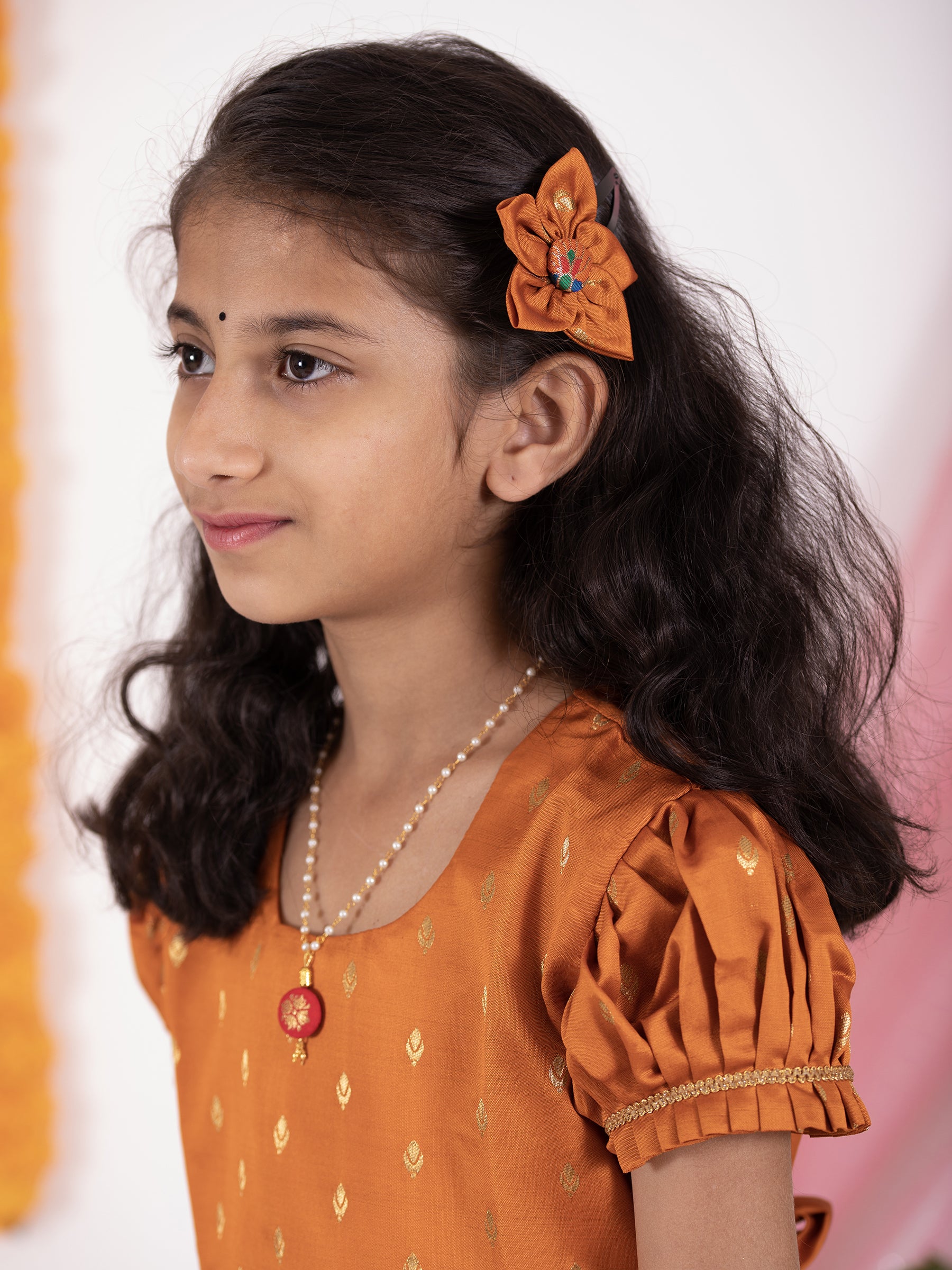 Rust colored taffeta silk frock with intricate peacock paithani border for Girl.Let your princess be as comfortable as in her casuals with carefully designed & crafted Comfort Ethnic Wear by Soyara Ethnics.Keep her fashion quotient high with timeless patterns, vibrant combinations and royal textiles.